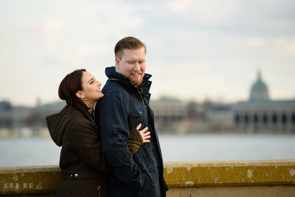 Jonas Green Park Annapolis Maryland engaged couple cuddling by the US Naval Academy photo by Leo Dj Photography.