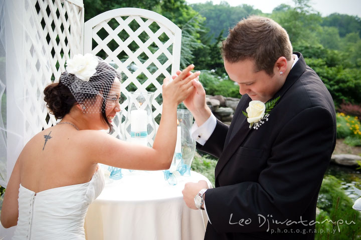 Bride and groom do a high five after lighting the unity candle. Falls Church Virginia 2941 Restaurant Wedding Photography