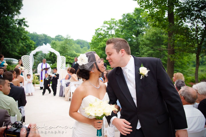 Bride and groom almost kiss at wedding recessional. Falls Church Virginia 2941 Restaurant Wedding Photography