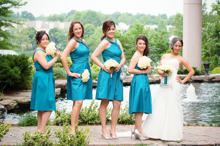 Bride, matron of honor, and bridesmaids holding bouquet and posing. Falls Church Virginia 2941 Restaurant Wedding Photography