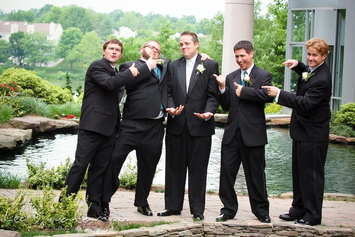 Best man and groomsmen pointing at groom. Falls Church Virginia 2941 Restaurant Wedding Photography