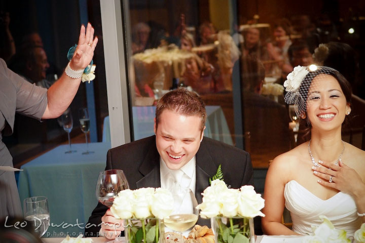 Groom and bride laughing listening to mother of groom's speech. Falls Church Virginia 2941 Restaurant Wedding Photographer