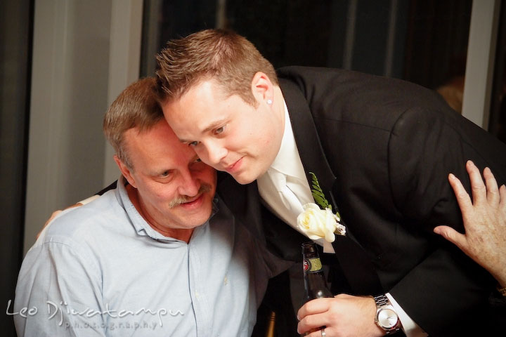 Groom hugs his father. Falls Church Virginia 2941 Restaurant Wedding Photographer
