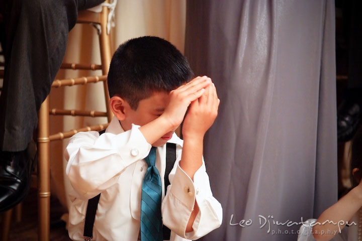 Ring bearer boy closed his eyes, not wanting to look at bride and groom kissing. Falls Church Virginia 2941 Restaurant Wedding Photographer