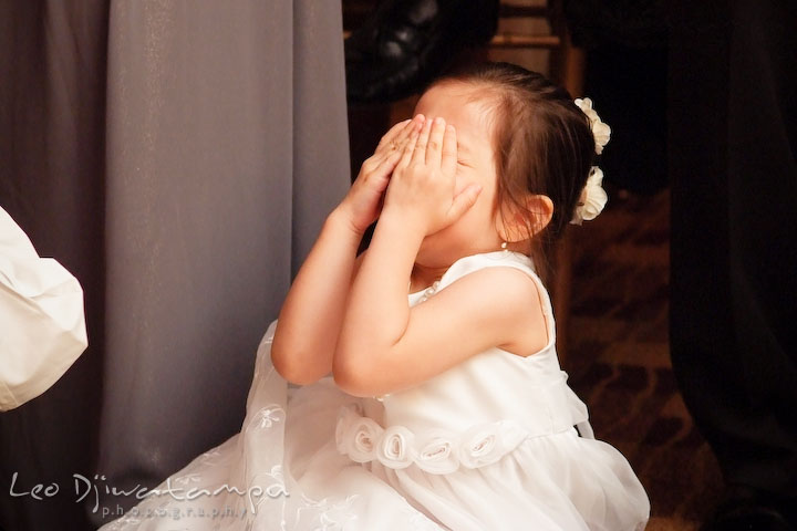 Flower girl closed her eyes. Do not want to look at bride and groom kissing. Falls Church Virginia 2941 Restaurant Wedding Photographer