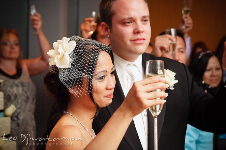 Bride, groom and all guests raised champangne glass, cheered. Falls Church Virginia 2941 Restaurant Wedding Photographer