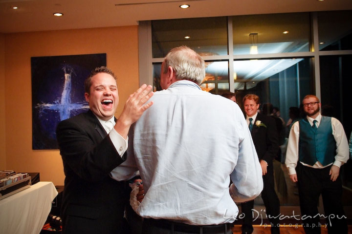 Groom patted on father's shoulder back. Falls Church Virginia 2941 Restaurant Wedding Photographer