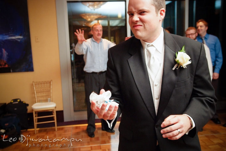 Groom ready to toss the garter to the single men. Falls Church Virginia 2941 Restaurant Wedding Photographer