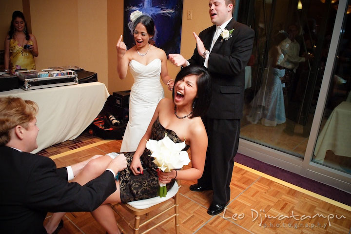Bride told guy to put garter higher on girls leg. Falls Church Virginia 2941 Restaurant Wedding Photographer