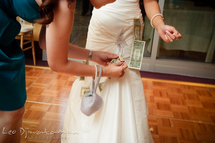 Lady guest attached money to bride's dress during money dance. Falls Church Virginia 2941 Restaurant Wedding Photographer