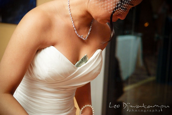 Bride with a dollar bill on her dress cleavage. Falls Church Virginia 2941 Restaurant Wedding Photographer
