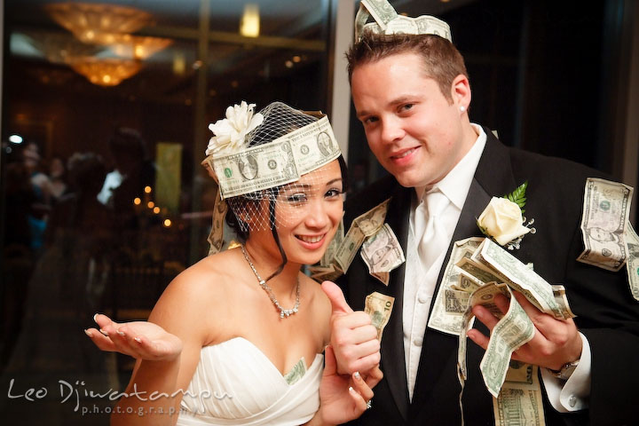 Bride and groom showing all the money they have on them from the dance. Falls Church Virginia 2941 Restaurant Wedding Photographer