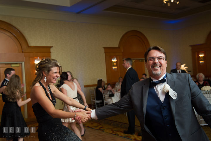 Father of the Groom dancing and laughing with his wife. Marriott Washingtonian Center wedding at Gaithersburg Maryland, by wedding photographers of Leo Dj Photography. http://leodjphoto.com
