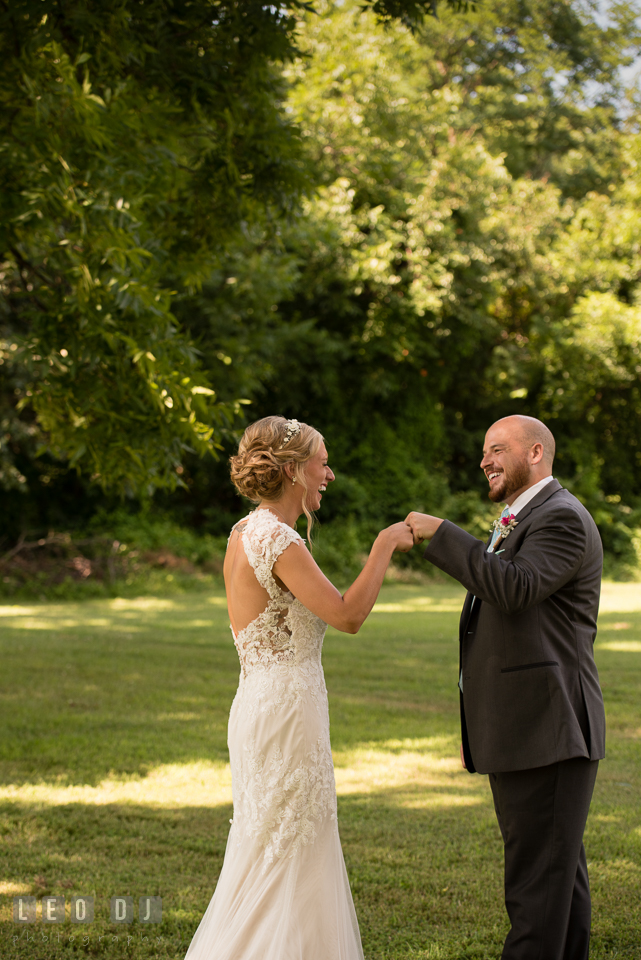 The Oaks Waterfront Inn Bride and Groom pounding fist during their first glance photo by Leo Dj Photography