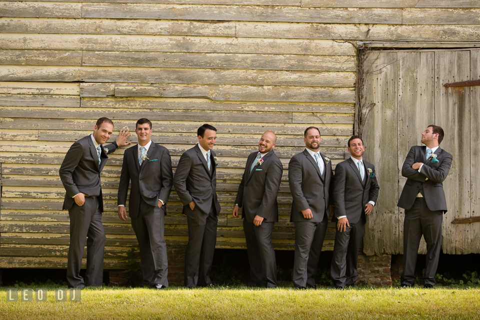 The Oaks Waterfront Inn Groom with Best Man and Groomsmen laughing while posing photo by Leo Dj Photography