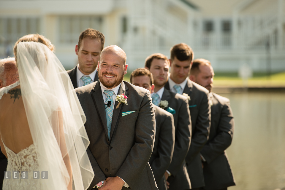 The Oaks Waterfront Inn Groom smiling seeing Bride during the ceremony photo by Leo Dj Photography