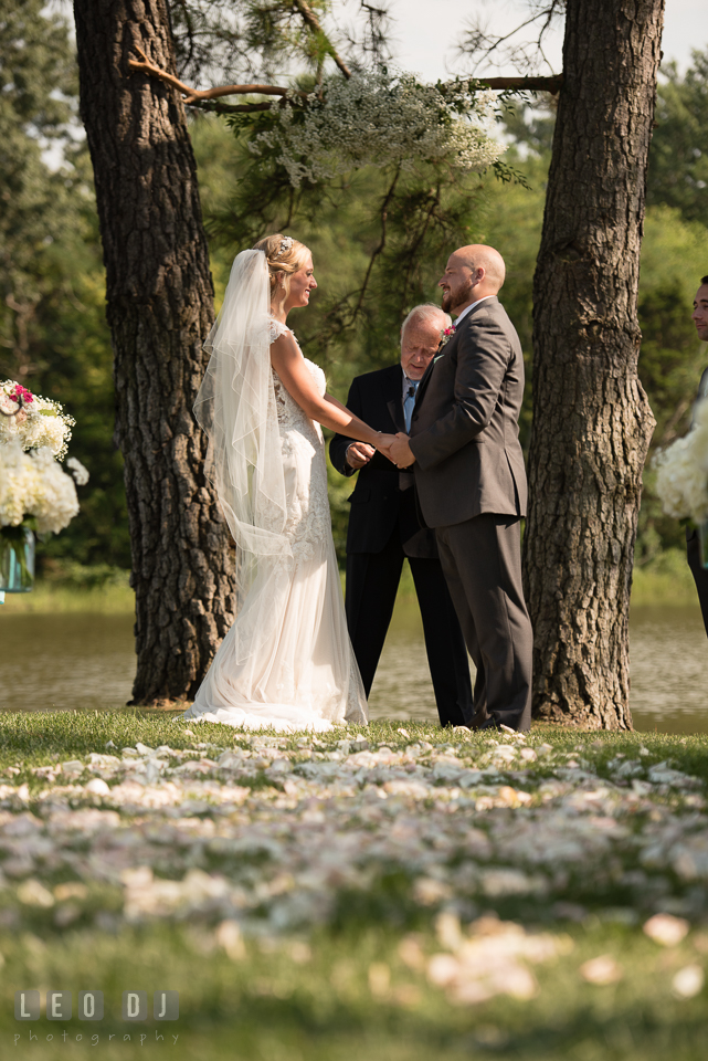 The Oaks Waterfront Inn Bride and Groom holding hands during ceremony photo by Leo Dj Photography