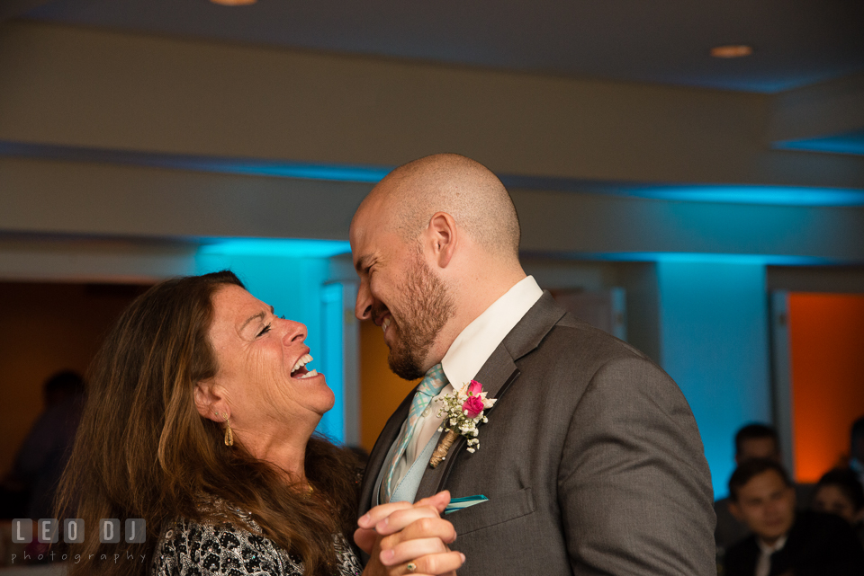 The Oaks Waterfront Inn Mother of Groom laughing while doing parent dance with son photo by Leo Dj Photography