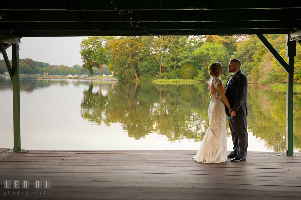 The Oaks Waterfront Inn Bride and Groom almost kiss on the dock with gorgeous water view photo by Leo Dj Photography