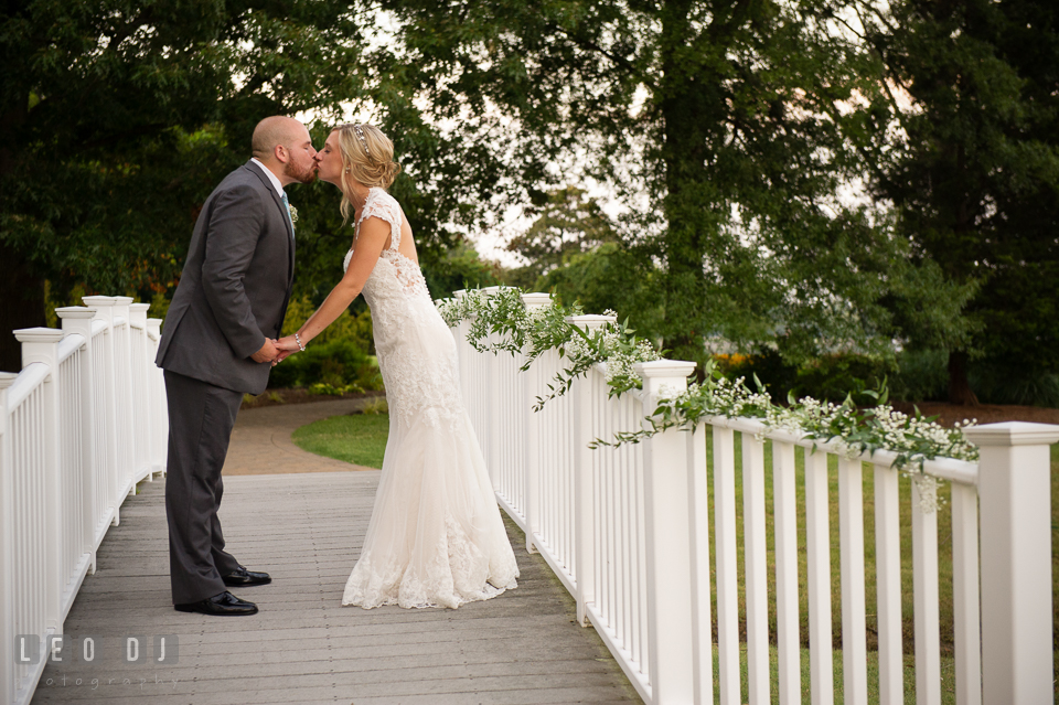 The Oaks Waterfront Inn Bride and Groom kissing on the Bridge photo by Leo Dj Photography