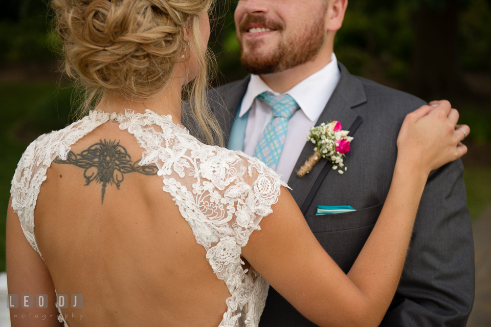 The Oaks Waterfront Inn Bride with open dress back holding Groom showing her tattoo photo by Leo Dj Photography