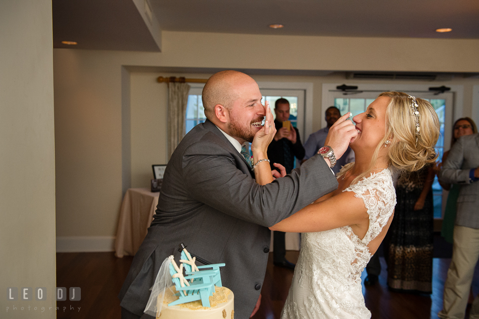 The Oaks Waterfront Inn Bride and Groom smash icing on each other during cake cutting photo by Leo Dj Photography