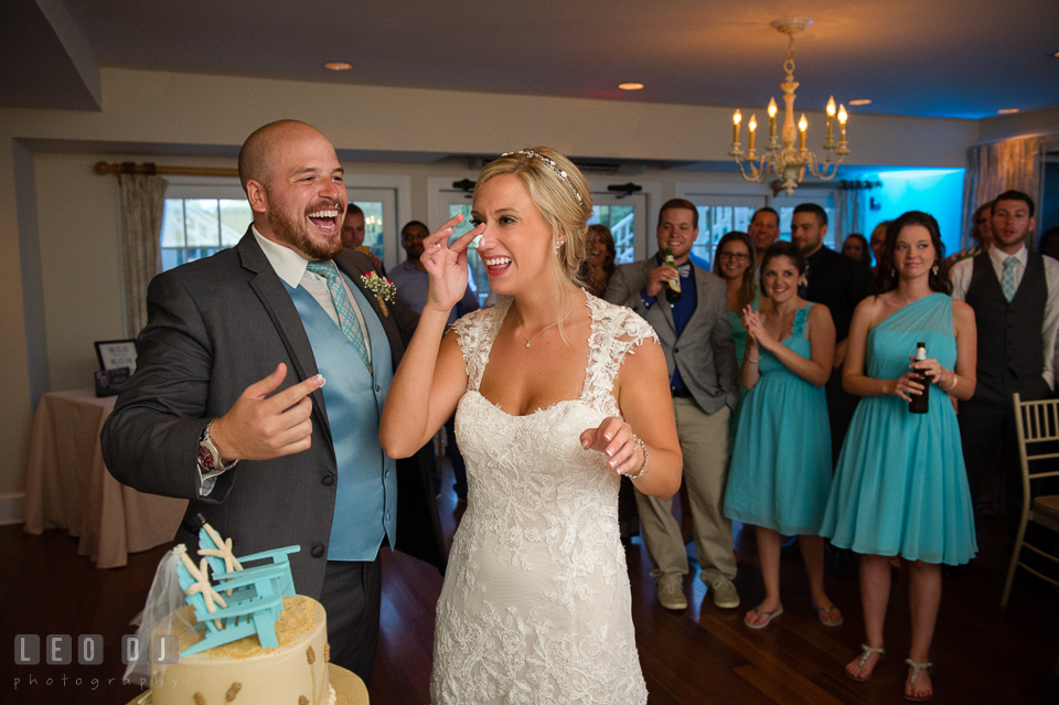 The Oaks Waterfront Inn Bride and Groom laughing after smearing cake icing on each other photo by Leo Dj Photography