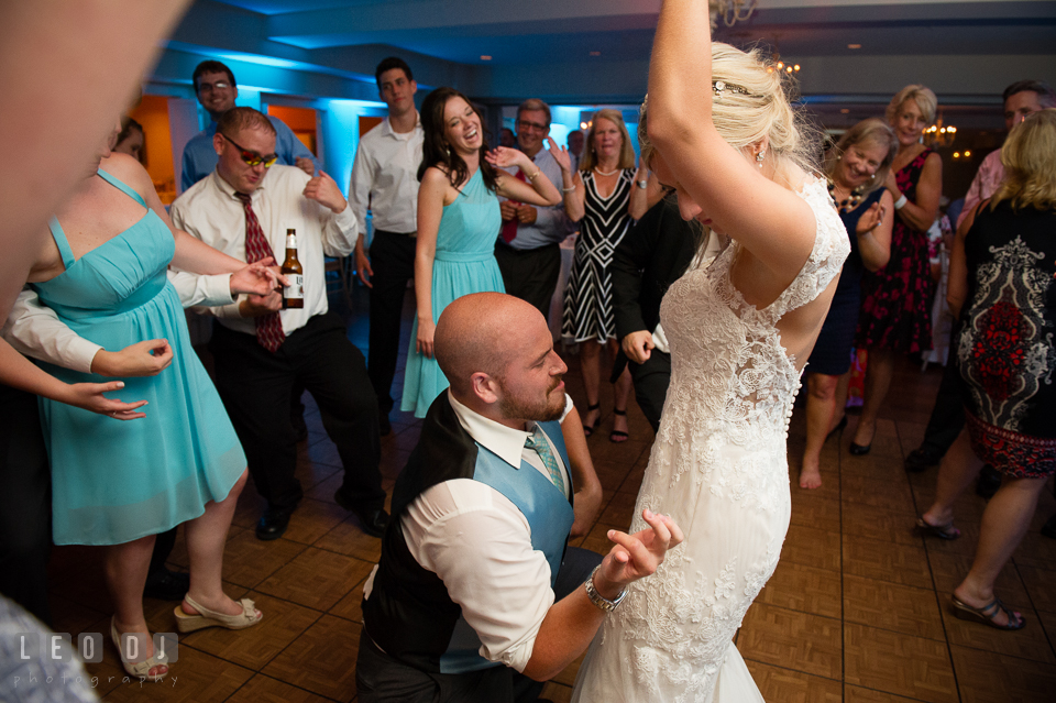 The Oaks Waterfront Inn Groom dancing and kneeling in front of Bride photo by Leo Dj Photography