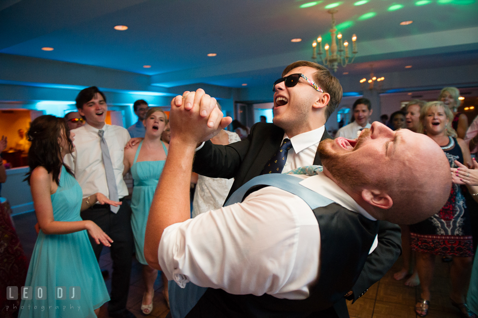 The Oaks Waterfront Inn Groom dancing and signing with another male guest photo by Leo Dj Photography