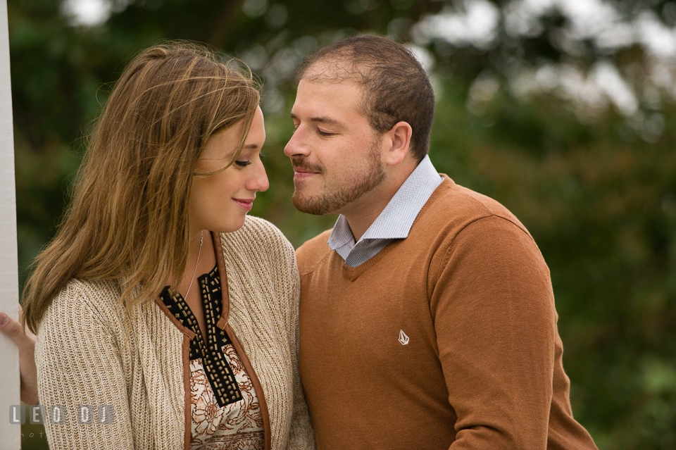 Engaged man about to kiss his fiancé. Eastern Shore Maryland pre-wedding engagement photo session at St Michaels MD, by wedding photographers of Leo Dj Photography. http://leodjphoto.com