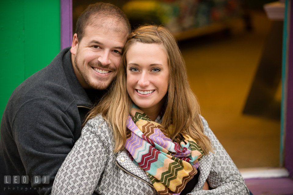 Engaged man snuggled and posing with his fiancée. Eastern Shore Maryland pre-wedding engagement photo session at St Michaels MD, by wedding photographers of Leo Dj Photography. http://leodjphoto.com