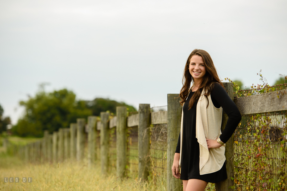 McDonogh High School Maryland senior girl posing and leaning by a fence photo by Leo Dj Photography.