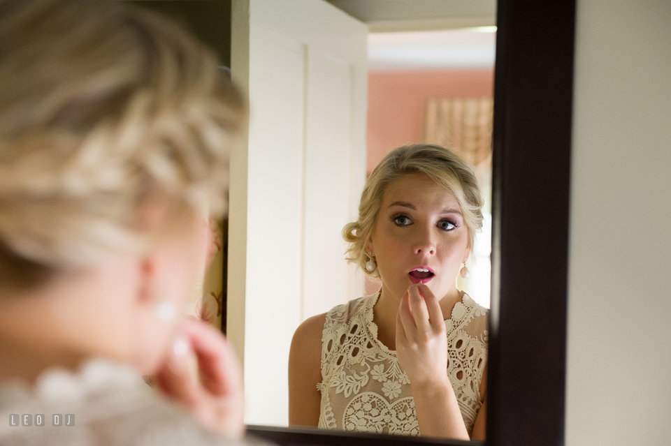 Kent Manor Inn bride put on lipstick before wedding ceremony photo by Leo Dj Photography