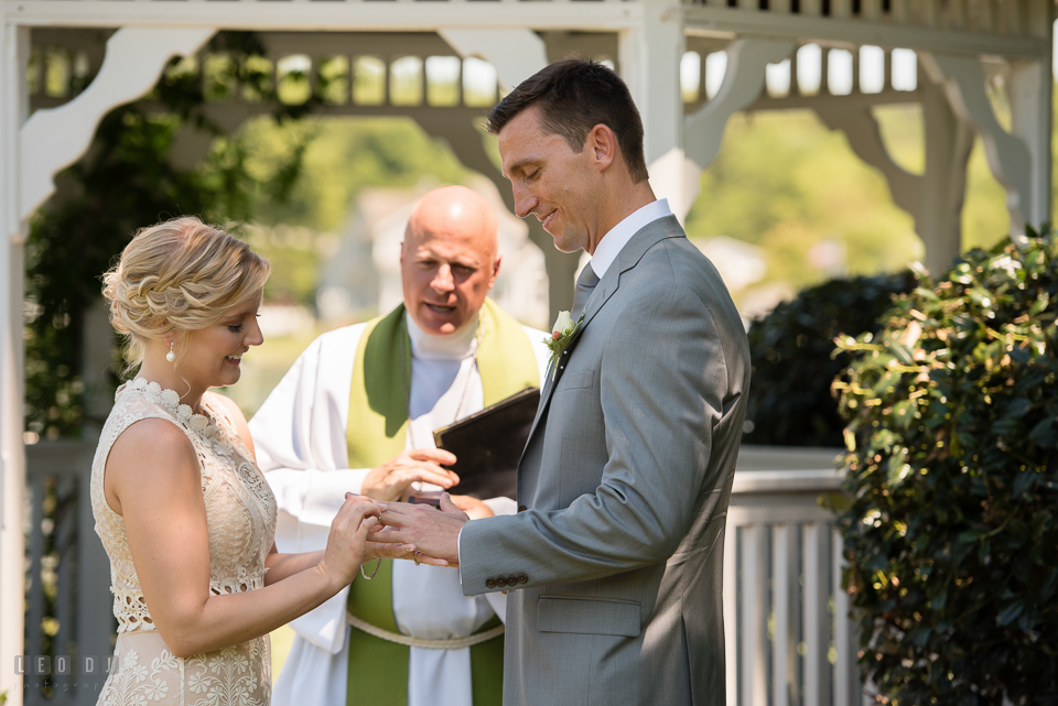 Kent Island Maryland bride put wedding ring on groom during wedding ceremony photo by Leo Dj Photography