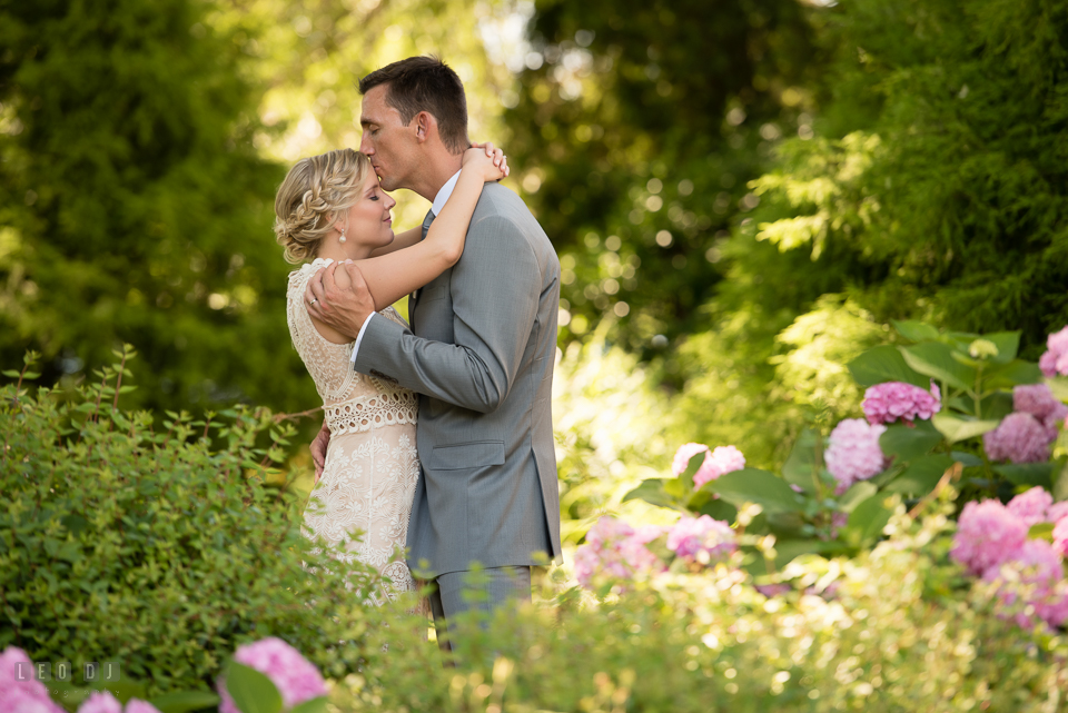 Kent Manor Inn wedding groom kissing bride in the flower garden photo by Leo Dj Photography