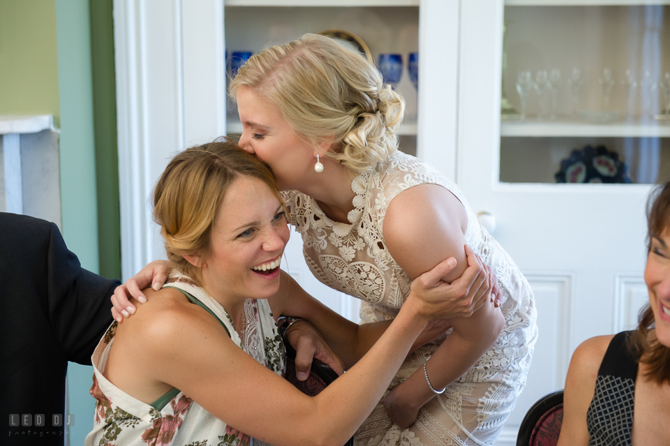 Kent Island Maryland bride hugged and kissed sister in-law during wedding reception photo by Leo Dj Photography