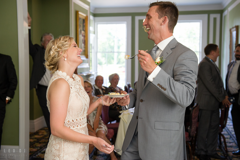 Kent Manor Inn bride and groom laughing during cake cutting at wedding reception photo by Leo Dj Photography