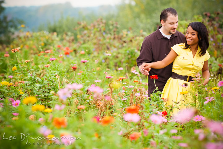 Engaged couple dancing in a flower field. Engagement pre-wedding photo session fruit tree farm barn flower garden by Leo Dj Photography