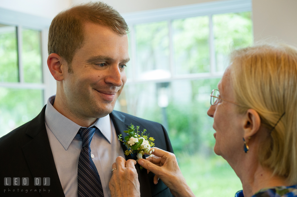 Mother of Groom pinning boutonniere on her son's jacket. Kent Island Maryland Chesapeake Bay Beach Club wedding photo, by wedding photographers of Leo Dj Photography. http://leodjphoto.com