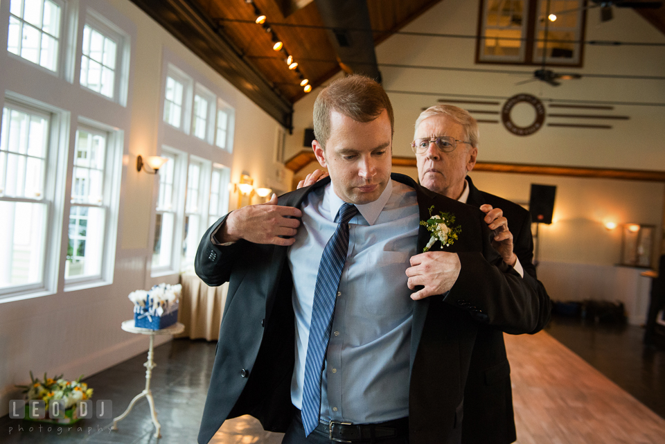 Father of the Groom helped put jacket on his son. Kent Island Maryland Chesapeake Bay Beach Club wedding photo, by wedding photographers of Leo Dj Photography. http://leodjphoto.com