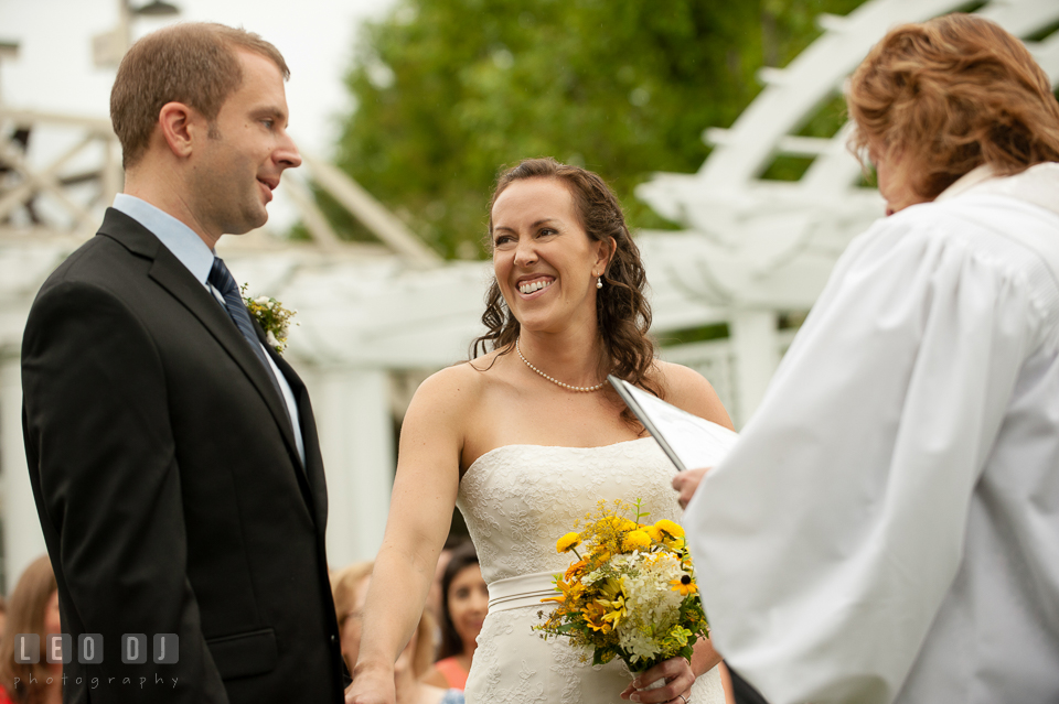 The Bride looking at Groom, smiling during the blessing ceremony. Kent Island Maryland Chesapeake Bay Beach Club wedding photo, by wedding photographers of Leo Dj Photography. http://leodjphoto.com