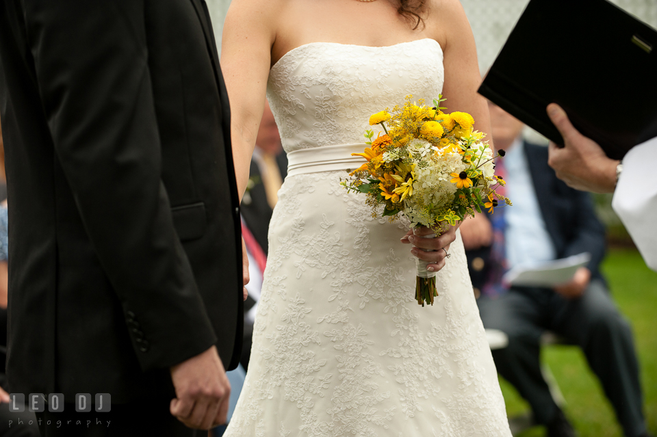 Bride and Groom held hands during the wedding ceremony. Kent Island Maryland Chesapeake Bay Beach Club wedding photo, by wedding photographers of Leo Dj Photography. http://leodjphoto.com