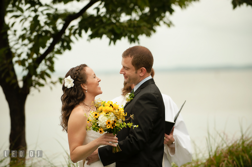 The Bride and Groom during the wedding ceremony about to do their first kiss. Kent Island Maryland Chesapeake Bay Beach Club wedding photo, by wedding photographers of Leo Dj Photography. http://leodjphoto.com