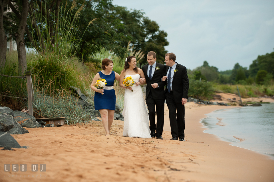 Bride, Groom, Maid of Honor, and Best Man walking together on the beach. Kent Island Maryland Chesapeake Bay Beach Club wedding photo, by wedding photographers of Leo Dj Photography. http://leodjphoto.com