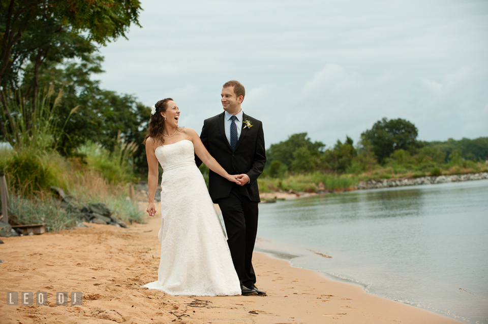 Bride and Groom on the Beach laughing together. Kent Island Maryland Chesapeake Bay Beach Club wedding photo, by wedding photographers of Leo Dj Photography. http://leodjphoto.com