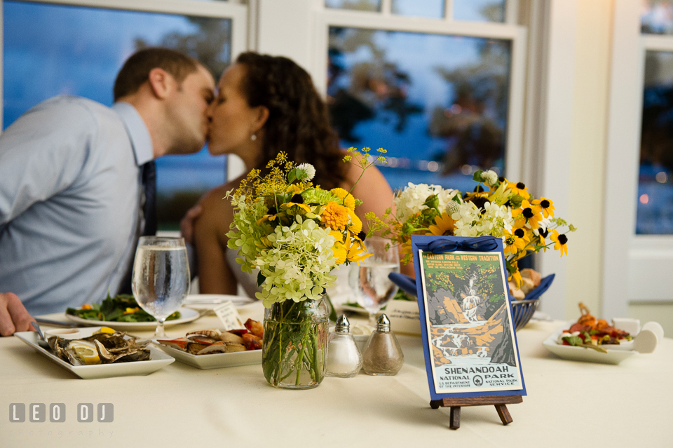 The Bride and Groom kissing at their sweetheart table. Kent Island Maryland Chesapeake Bay Beach Club wedding photo, by wedding photographers of Leo Dj Photography. http://leodjphoto.com