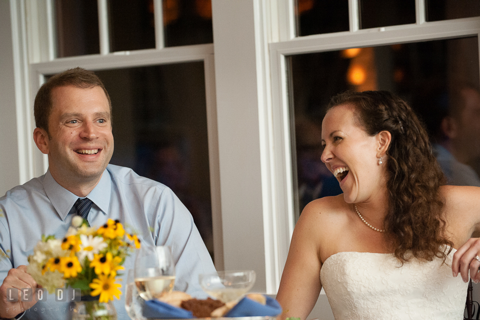 Bride and Groom laughing, enjoying the toast speeches. Kent Island Maryland Chesapeake Bay Beach Club wedding photo, by wedding photographers of Leo Dj Photography. http://leodjphoto.com