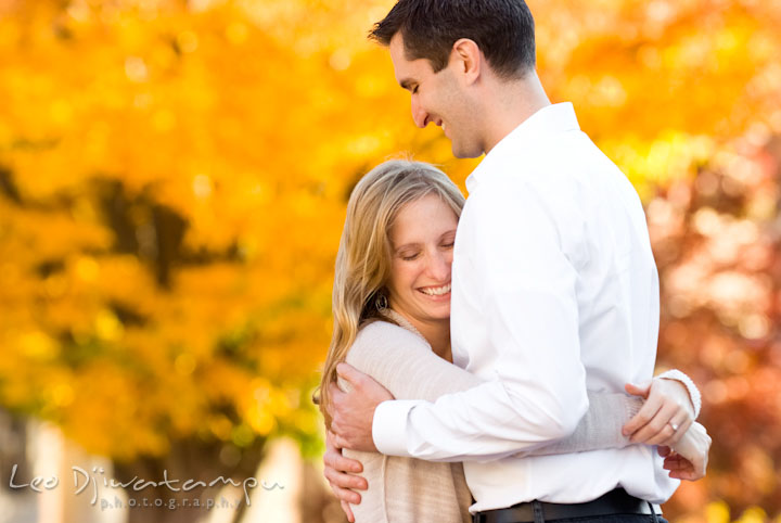 Engaged guy hugging his fiancee. Pre-wedding engagement photo session at Washington College and Chestertown, Maryland, by wedding photographer Leo Dj Photography.