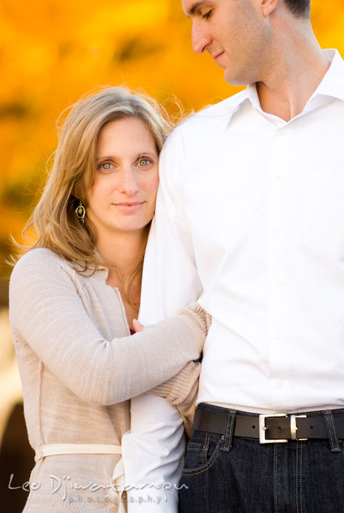 Engaged girl holding her fiancé's arm. Pre-wedding engagement photo session at Washington College and Chestertown, Maryland, by wedding photographer Leo Dj Photography.