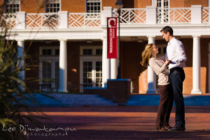 Happy engaged couple dancing by the CAC. Pre-wedding engagement photo session at Washington College and Chestertown, Maryland, by wedding photographer Leo Dj Photography.